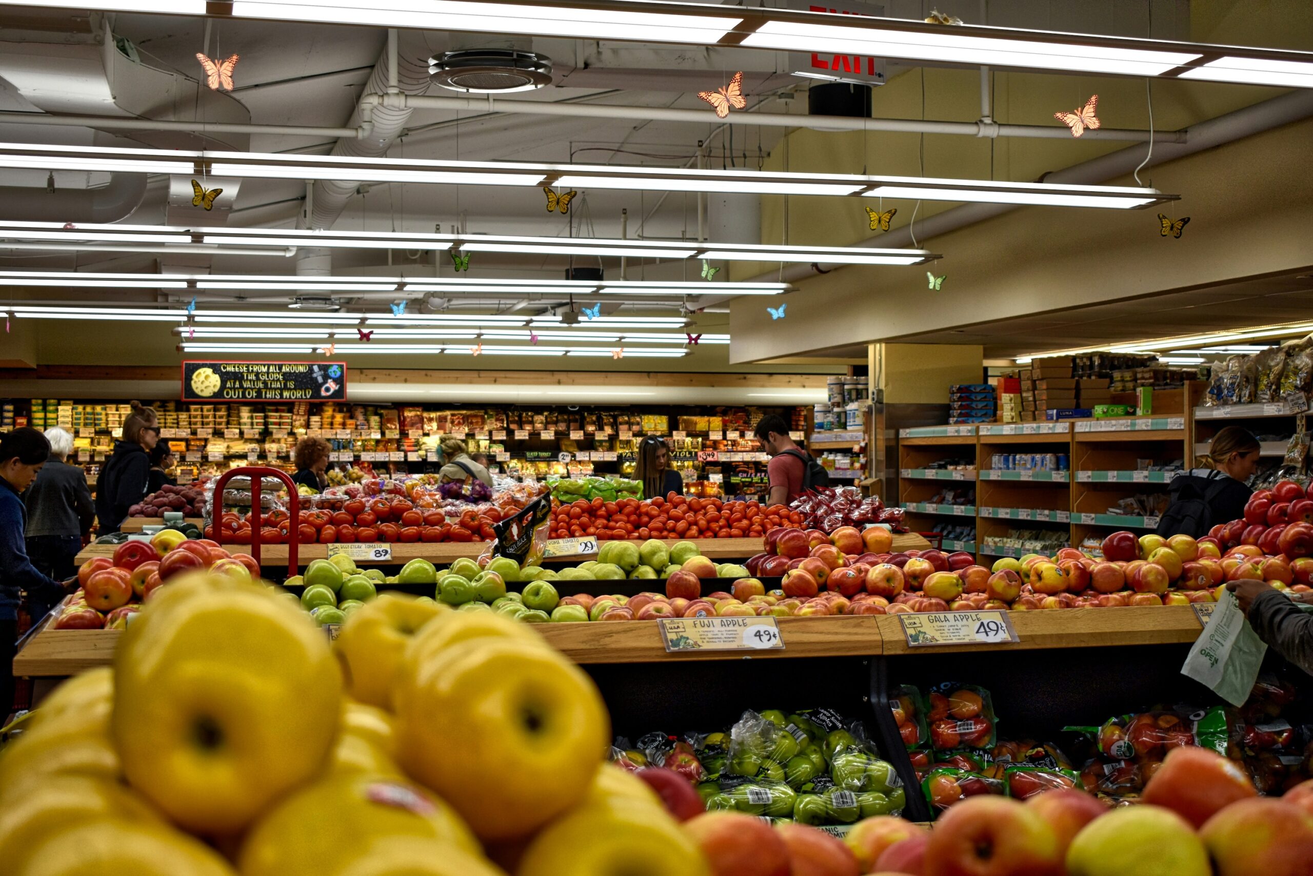 Color photograph of a variety of fruits and vegetables at a supermarket.