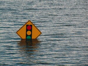 Image of a road sign submerged in water during a flood.